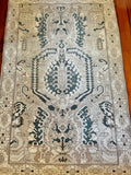 measurements: 4'8" x 7'2.5"  Palette includes deep teal, taupe, tan and sand.  Vintage Turkish rug from Anatolia, handmade c.1970.&nbsp;