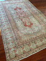 Dimensions: 4.5' x 6'2.5"  Palette includes blush, rouge, pistachio and walnut.  Vintage Turkish Anatolian rug c.1970, hand knotted of wool.&nbsp;