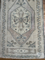 Dimensions: 1'11" x 3'3.5"  Palette includes teal, silvery beige, muted ruby and mocha.   Vintage Turkish rug, handmade of wool c.1960. 