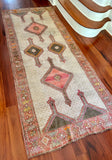 Measures 4'2.5" x 10'5"  Palette includes rouge, off-white, peanut, brown, orange and yellow.  Vintage Turkish rug c.1960, handmade of wool.   Such a unique textile! Low pile and very soft to the touch. 