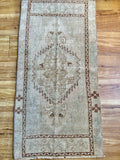 Measures 1'8" x 3'3"  Palette includes green tones, brown and a shimmery tan   Vintage Turkish, handmade of wool 