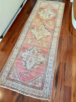 Measures 3'5" x 10'5"  Palette includes rose to punch, dark taupe, flaxen, and pops of fuchsia.   Vintage Turkish Runner c.1960, handmade of wool.  Low pile and soft to the touch. 