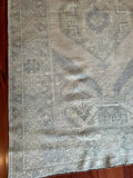 Measures 3'9.5" x 6'2"  Palette includes a gray-blue, muted tones of yellow and pink   Vintage Turkish, handmade of wool approximately 60 years old  