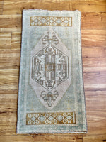 Measures 1'7" x 3.5'  Palette includes a soft mint, brown, ecru, and golden yellow   Vintage Turkish, handmade of wool 