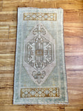 Measures 1'7" x 3.5'  Palette includes a soft mint, brown, ecru, and golden yellow   Vintage Turkish, handmade of wool 