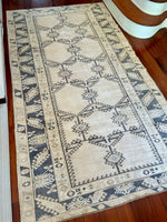 Measures 5'4.5" x 9'9.5"  Palette includes steel blue, ivory and cloud grey.   Vintage Turkish area rug c.1960, handmade of wool.  Low pile, sturdy and soft to the touch. 