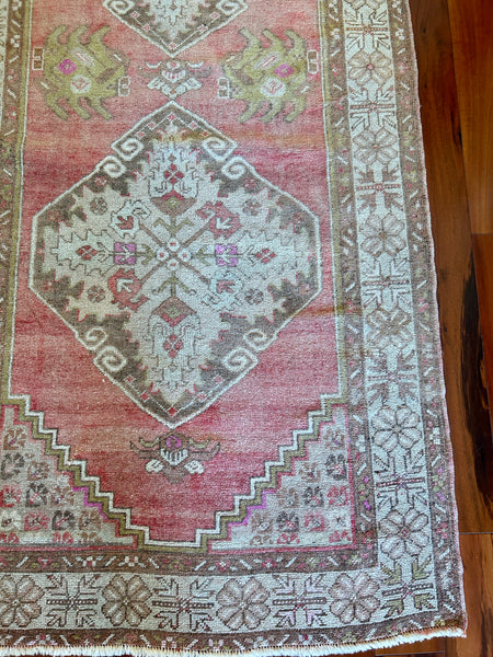 Measures 3'5" x 10'5"  Palette includes rose to punch, dark taupe, flaxen, and pops of fuchsia.   Vintage Turkish Runner c.1960, handmade of wool.  Low pile and soft to the touch. 