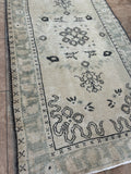 Dimensions: 3'1" x 5'9"  Palette includes a soft blue/green, saltbox, and charcoal.   Vintage Turkish c.1960, knotted by hand of wool. Low pile, sturdy. 