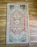 Dimensions: 1'8" x 3'  Palette includes pink, grey, light and dark caramel, and sage.   Vintage Turkish c.1970. Handmade of wool. 