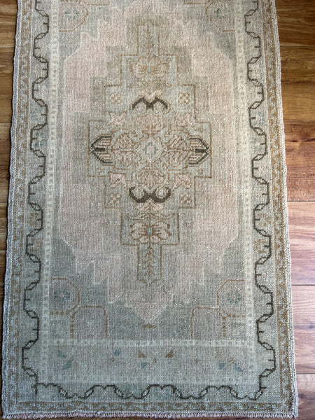 Dimensions: 1'8.5" x 3'1.5"  Palette includes green and blue tones, silvery beige, mocha and peanut.   Vintage Turkish c.1970. Handmade of wool. 