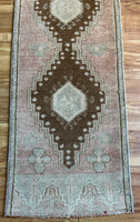 Dimensions: 1'5" at one end and narrows to 1'3.5" x 3'7"  Palette includes soft rosewood, grey/blue, and pecan.   Vintage Turkish c.1970. Handmade of wool. 