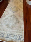 Dimensions: 2'12" x 12'3.5"  Palette includes a soft rosewood, olive, steel blue, baby pink, sage, and ecru.   Vintage Turkish area rug c.1970. Hand woven of wool. Sturdy. 