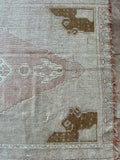 Dimensions: 3'8.5" x 7'11.5"  Palette is soft and includes muted rose, blue, golden brown and moonstone.   Hand-knotted vintage Turkish rug c.1960. Made of wool.  This rug would be precious in a nursery or girl's room.  