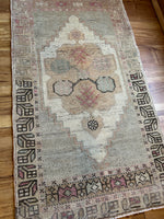 Dimensions: 1'9" x 3'2.5"  Palette includes magenta, blue/green, soft bronze, chocolate and cream.   Vintage Turkish c.1960, hand knotted of wool. 