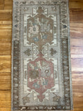Dimensions: 1'10" x 3'5.5"  Palette includes rosewood, gray, green, tawny, and ecru.   Vintage Turkish rug hand knotted of wool c.1960. 