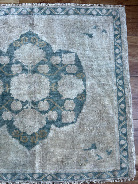 Dimensions: 2'3.5 x 2'1.5  Palette includes steel blue, flaxen and tan   Vintage Turkish c.1970, hand knotted of wool. 