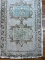 Dimensions: 1'8.5 x 3'6.5  Palette includes electric blue, cream, brown, and green undertones.   Vintage Turkish c.1970, hand knotted of wool.