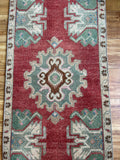 Dimensions: 1'9 x 3'8.5  Palette includes ruby, pine, cinnamon, pops of fuchsia and sapphire.  Vintage Turkish c.1970, handmade of wool.  