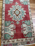 Dimensions: 1'9 x 3'8.5  Palette includes ruby, pine, cinnamon, pops of fuchsia and sapphire.  Vintage Turkish c.1970, handmade of wool.  