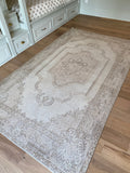 Dimensions: 5'1.5" x 8'8"  Palette is neutral including wheat, ecru, mahogany, and hints of taupe in the middle and along the border.   Vintage Turkish approximately 60 years old, handmade of wool. Sturdy. 